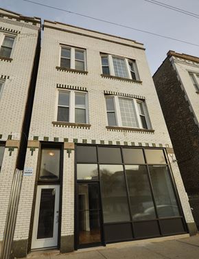 Chicago apartment for rent - a white brick building with a large glass door