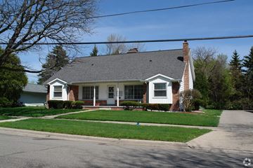 Lansing apartment for rent - a house on the corner of a street with grass