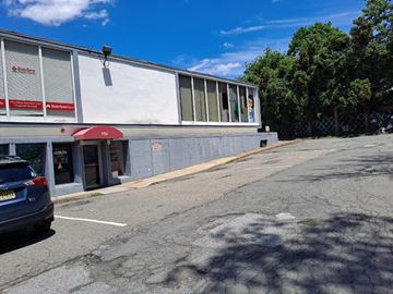 Paterson apartment for rent - a white building with a car parked in front of it