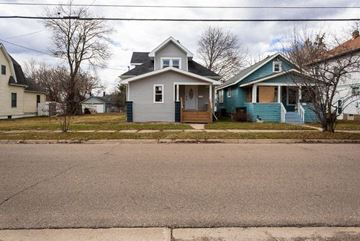 Lansing apartment for rent - a blue and white house on the side of a street