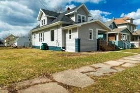 Lansing apartment for rent - a white house with a sidewalk in front of it
