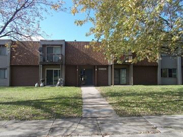 Hobart apartment for rent - the front of a brick building with a sidewalk and grass