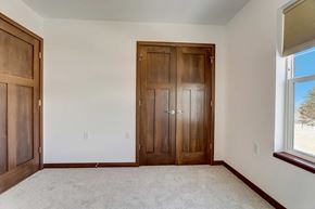 Mount Horeb house for rent - a bedroom with two doors and a carpeted floor