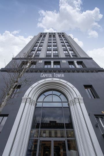 Salem apartment for rent - A tall building with a sign that says Capitol Tower.