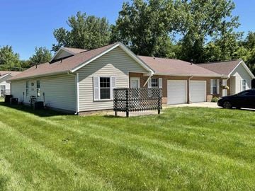 Heath apartment for rent - a white house with a yard and a fence