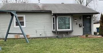 Lawrence house for rent - A house with a grey roof and a grey door.
