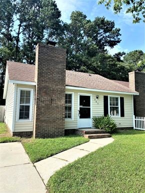 Jacksonville house for rent - a small white house with a brick facade and a sidewalk