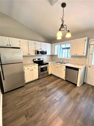 Jacksonville house for rent - a kitchen with white cabinets and stainless steel appliances