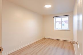 Windsor apartment for rent - an empty bedroom with wood floors and a window