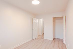 Windsor apartment for rent - a renovated living room with white walls and wood flooring