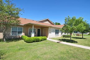 Boerne apartment for rent - the front of a house with a lawn and trees