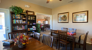 Kerrville apartment for rent - a dining room and living room with a table and chairs and a bookshelf