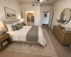 Kerrville apartment for rent - A bedroom with a large bed, a mirror, and a rug.