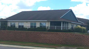 New Braunfels triplex for rent - a house with a black roof and a brick wall
