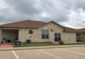 Weatherford townhouse for rent - a brick building with a sign on the side of it