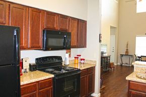 Fredericksburg townhouse for rent - a kitchen with black appliances and granite counter tops