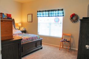 Fredericksburg townhouse for rent - a bedroom with a bed and a dresser and a window