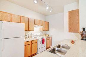 Cleburne townhouse for rent - a kitchen with a stove refrigerator and a sink