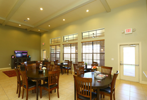 Midland apartment for rent - a dining room with tables and chairs and large windows