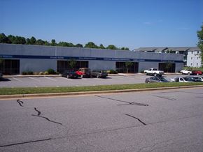 Kernersville apartment for rent - an empty parking lot with cars in front of a building