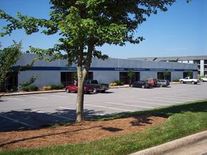 Kernersville apartment for rent - a parking lot with cars in front of a building
