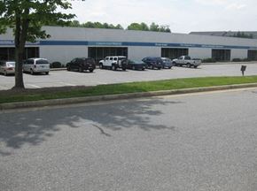 Kernersville apartment for rent - a parking lot with cars parked in front of a building