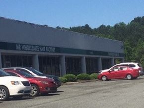 Burlington apartment for rent - A Mr. Wholesale Wax Factory store with cars parked outside.