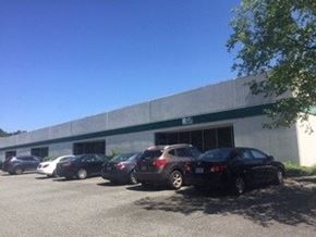 Burlington apartment for rent - A parking lot with cars and a building in the background.
