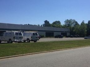 Burlington apartment for rent - A building with a row of vans parked in front.