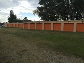 Thomasville apartment for rent - a row of orange roll up garage doors on a building