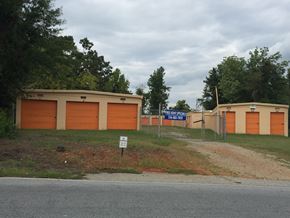 Thomasville apartment for rent - a building with two garages and a street sign in front of it