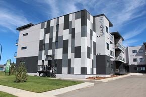 Saskatoon apartment for rent - A modern building with a black and white checkered pattern on its facade.
