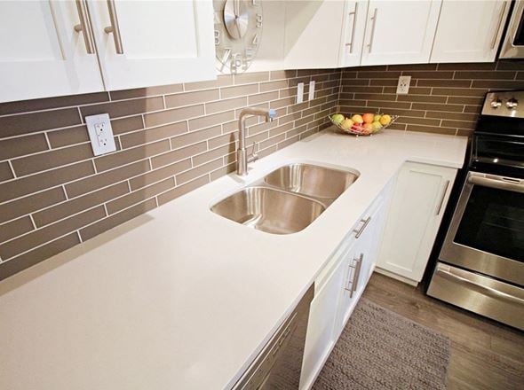 Saskatoon apartment for rent - A kitchen with a sink and a bowl of fruit on the counter.