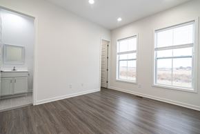 Inwood apartment for rent - an empty living room with white walls and wood flooring