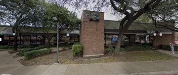 Richardson apartment for rent - the front of a building with a brick pillar and trees