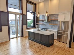Chicago apartment for rent - a kitchen with a center island and a stainless steel refrigerator
