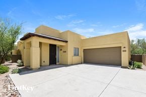 Tucson house for rent - A modern house with a garage and a driveway.