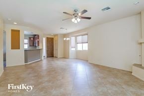 Tucson house for rent - A spacious room with a ceiling fan and tiled flooring.
