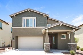 Goodyear house for rent - A modern house with a garage door and a brown door.