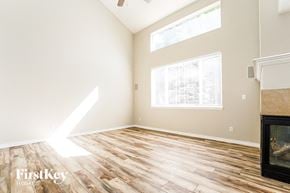 Aurora house for rent - A room with wooden flooring and a fireplace is shown.