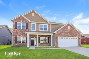 Avon house for rent - A brick house with a garage and a sign that says FirstKey Homes.