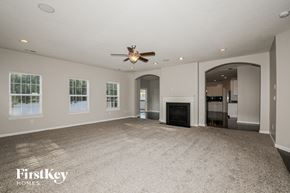 Avon house for rent - A spacious living room with a fireplace and a ceiling fan.