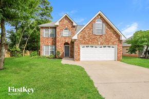 Murfreesboro house for rent - a brick house with a white garage door and a lawn