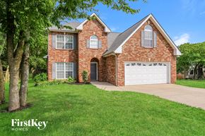 Murfreesboro house for rent - a brick house with a white garage door and a lawn