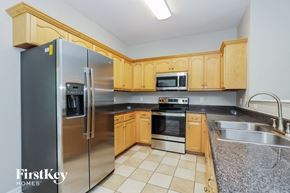 Murfreesboro house for rent - a kitchen with wooden cabinets and stainless steel appliances