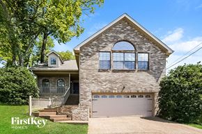 Nashville house for rent - a brick house with a garage and a white garage door