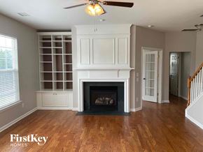 Charlotte house for rent - a living room with a fireplace and a bookcase