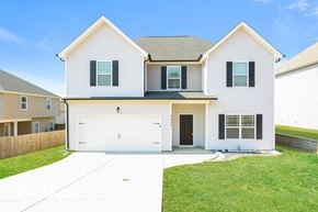 Clarksville house for rent - a white house with a garage and a green lawn