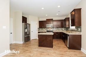 Clarksville house for rent - a kitchen with wooden cabinets and stainless steel appliances