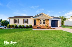 Archdale house for rent - A house with a well-maintained lawn and a clear sky in the background.